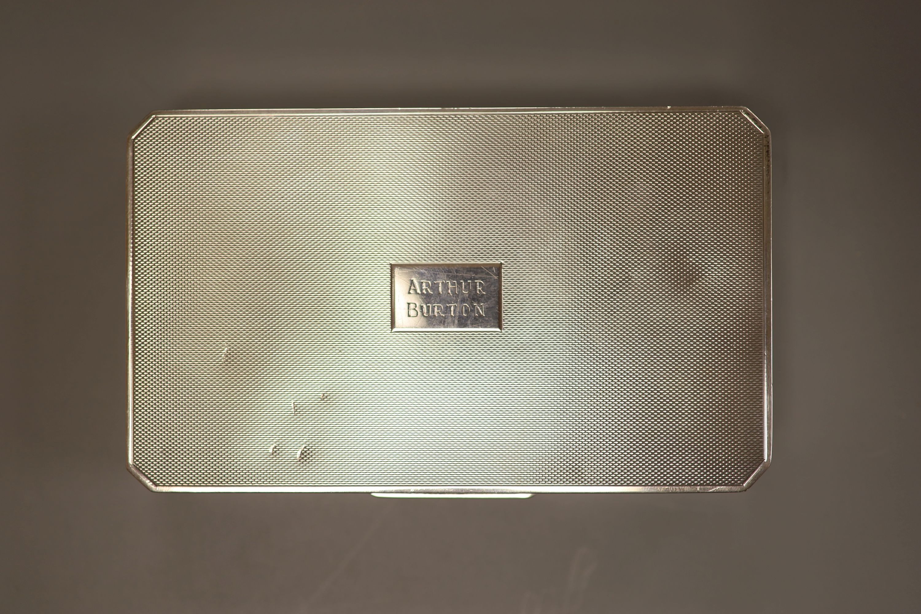 Three silver mounted cigarette cases, largest 17.9cm.